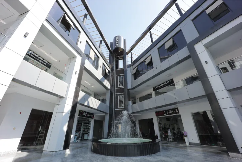 Open-air retail promenade with palm trees